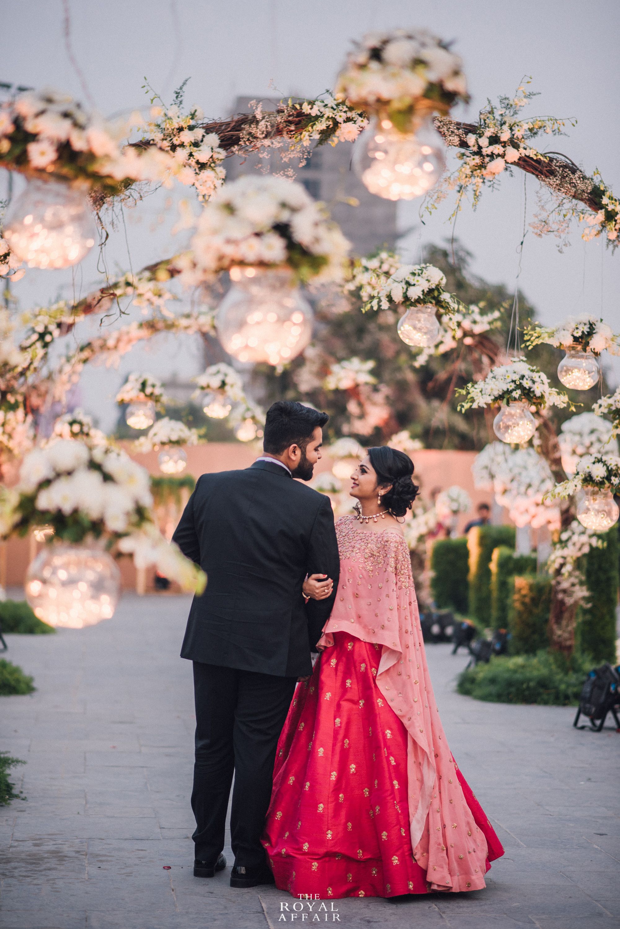 Elegant and fashionable indian friends couple of woman in saree and man in  suit sitting on bench. 10579774 Stock Photo at Vecteezy