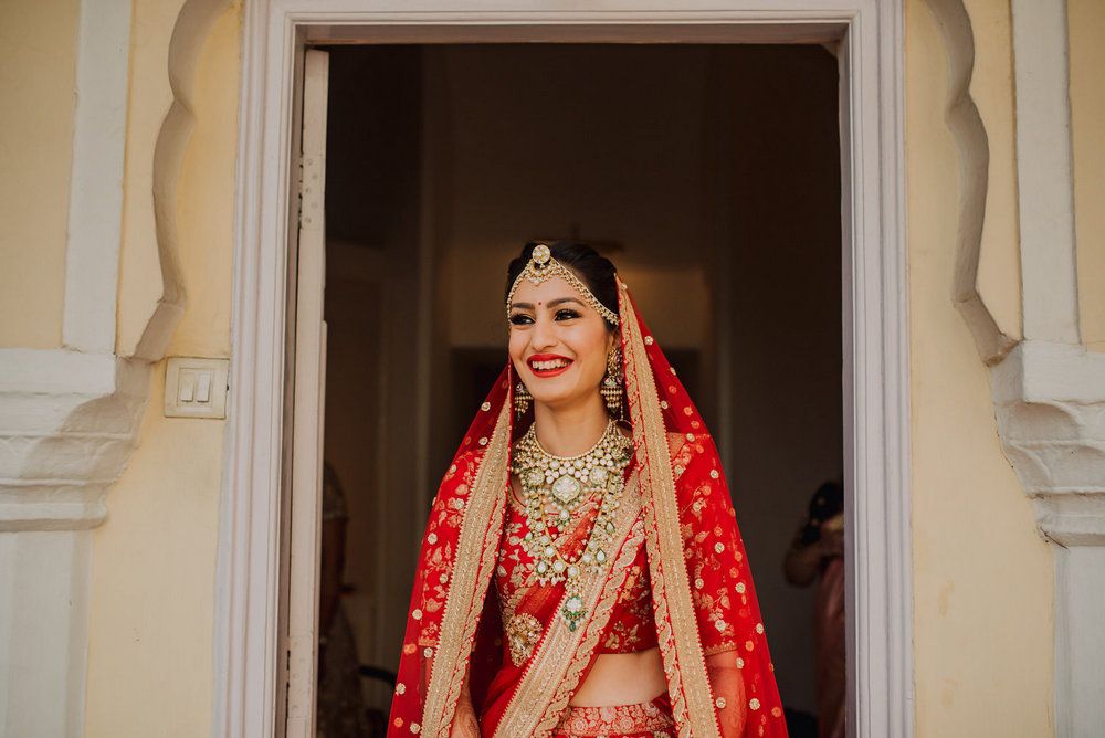 A Royal Jaipur Wedding With The Bride In A Dazzling Red Lehenga | WedMeGood