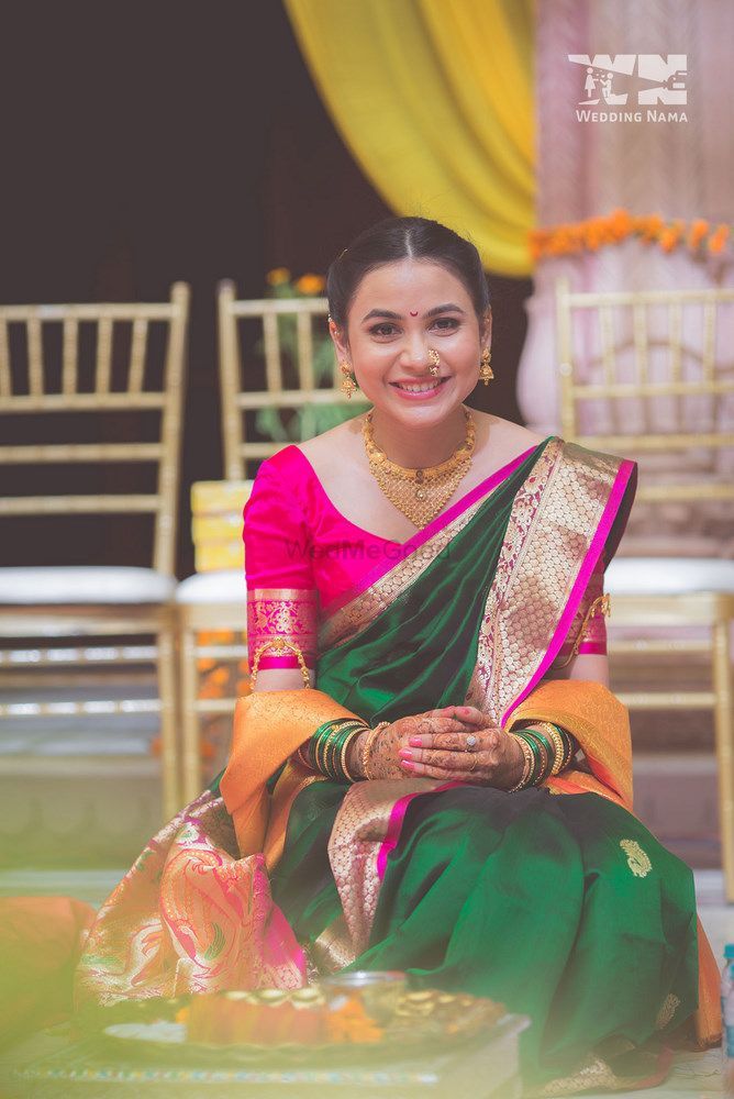 Green and pink bridal nauvari saree with jewel tone on the borders