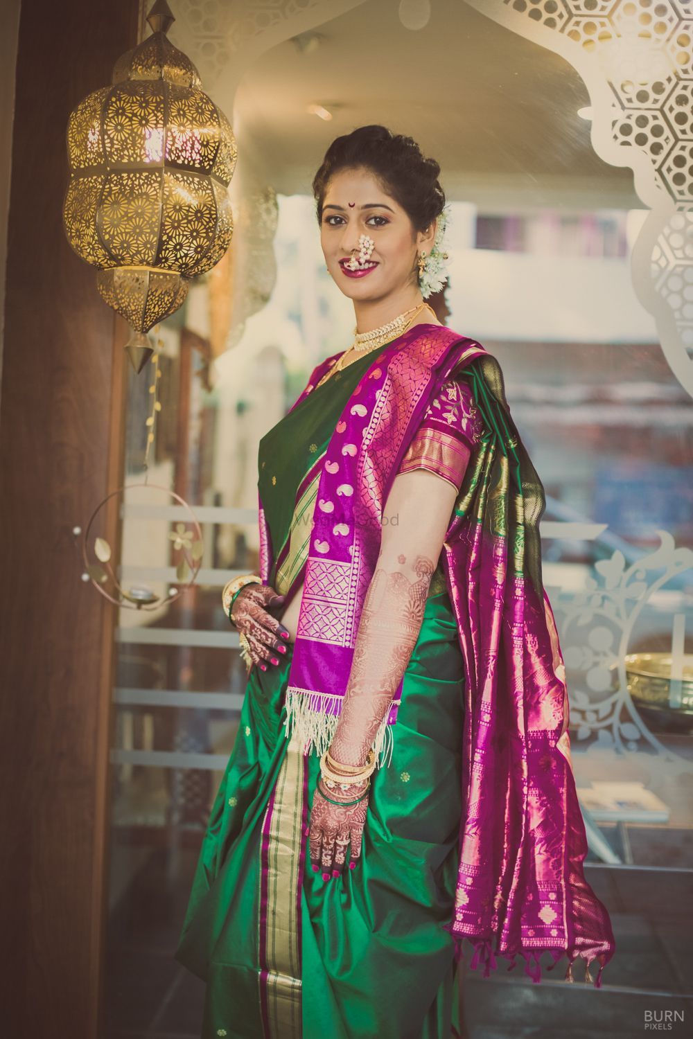 Purple and green nauvari saree with golden border