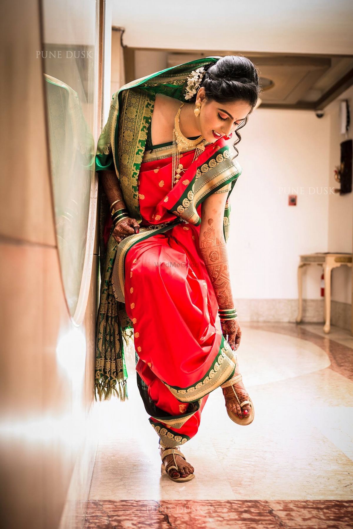 Cherry Red Bridal nauvari saree with green jewel toned borders