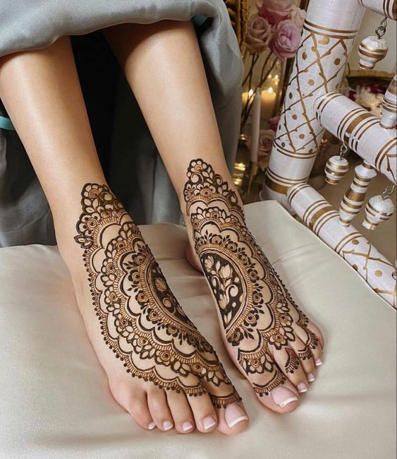 Symmetrical henna designs on feet
