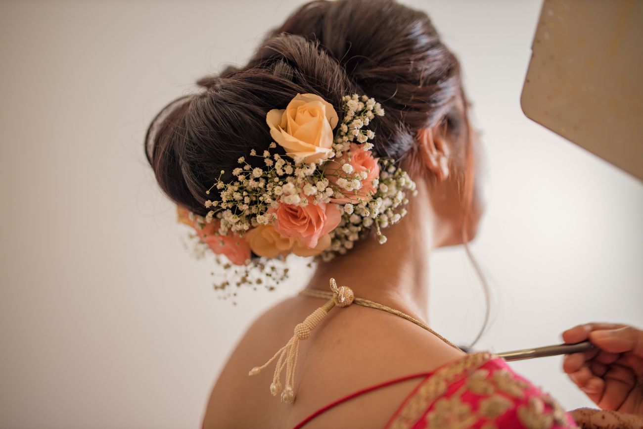 Bridal Bun hairstyle with roses and baby breathes