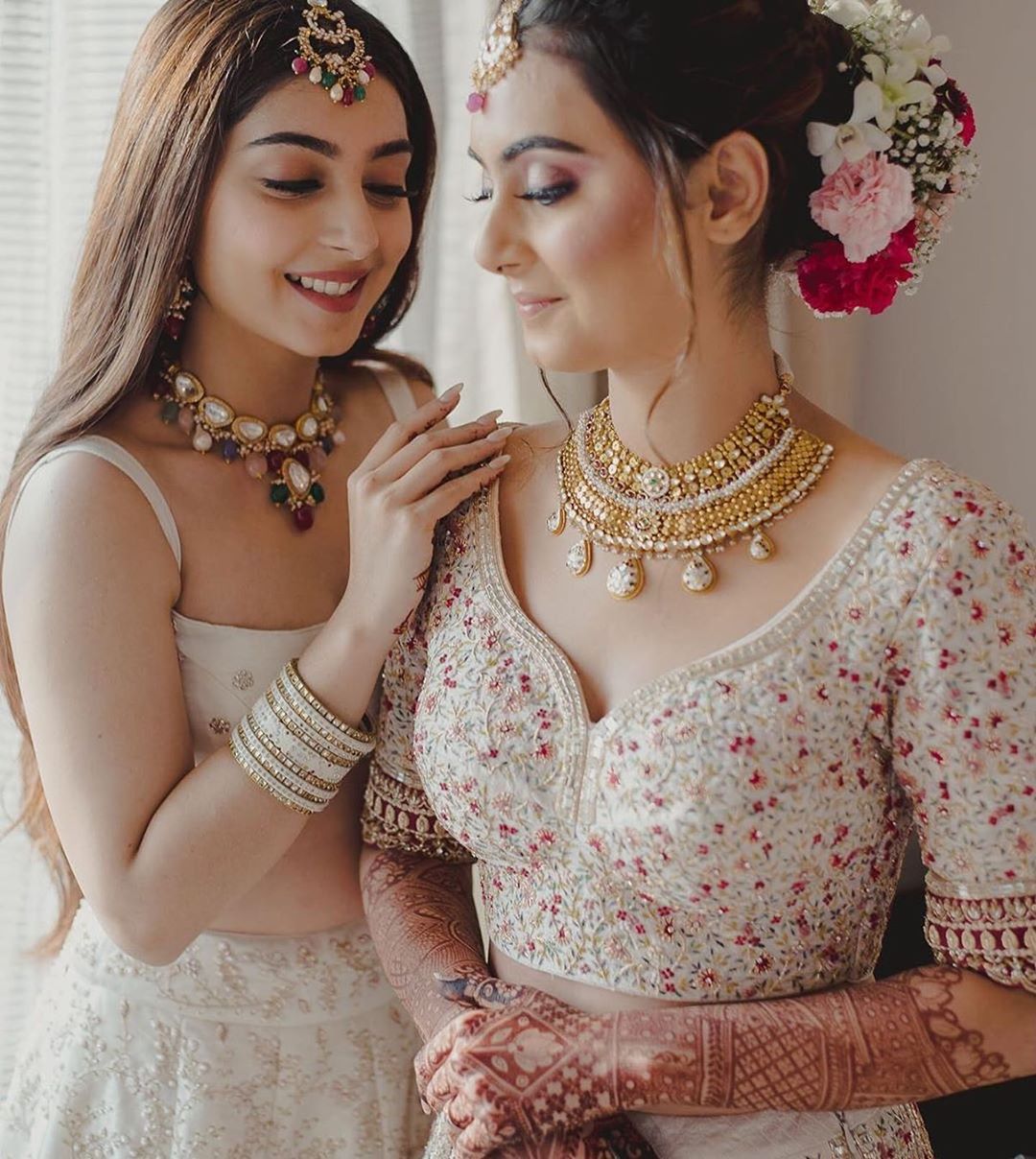 bride with her sister getting ready shot
