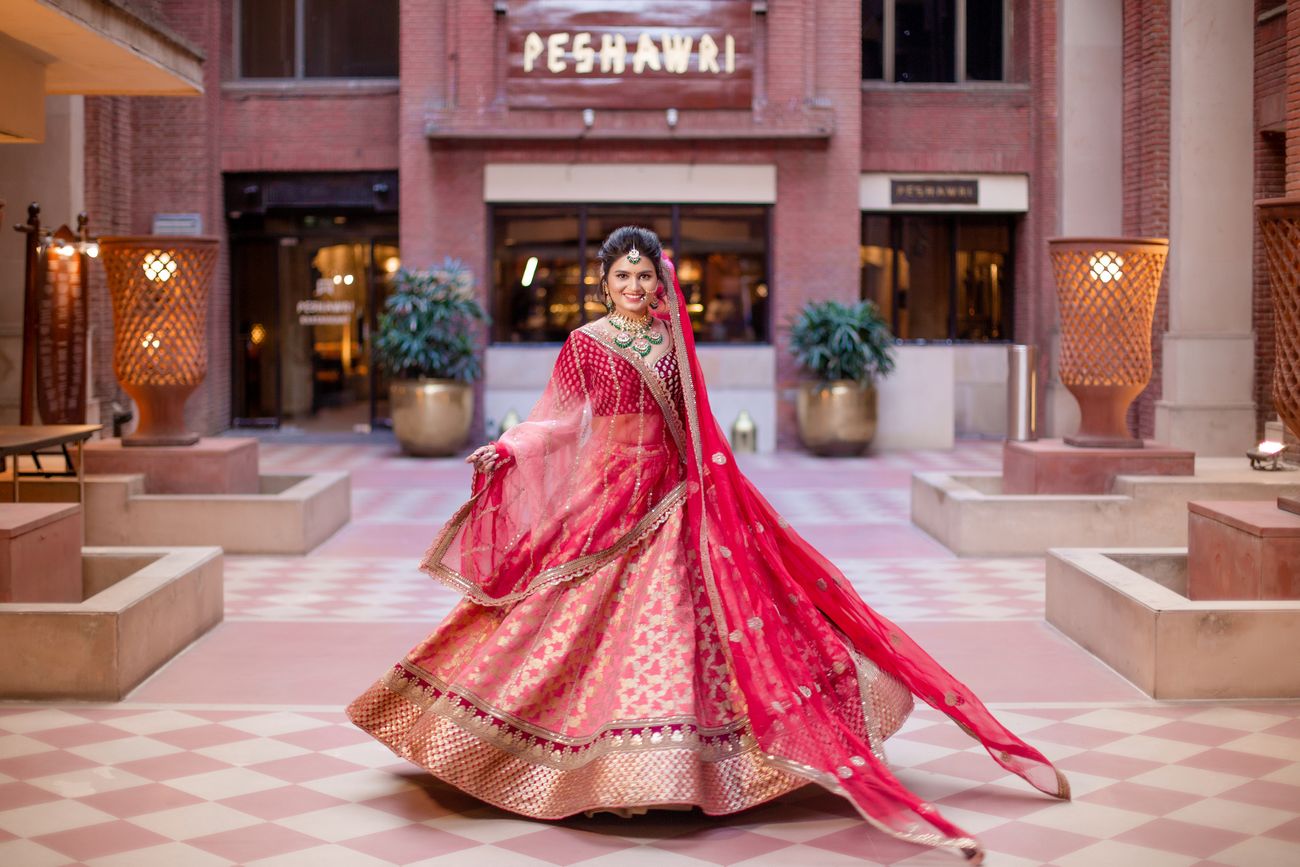 Twirling bride in a traditional lehenga