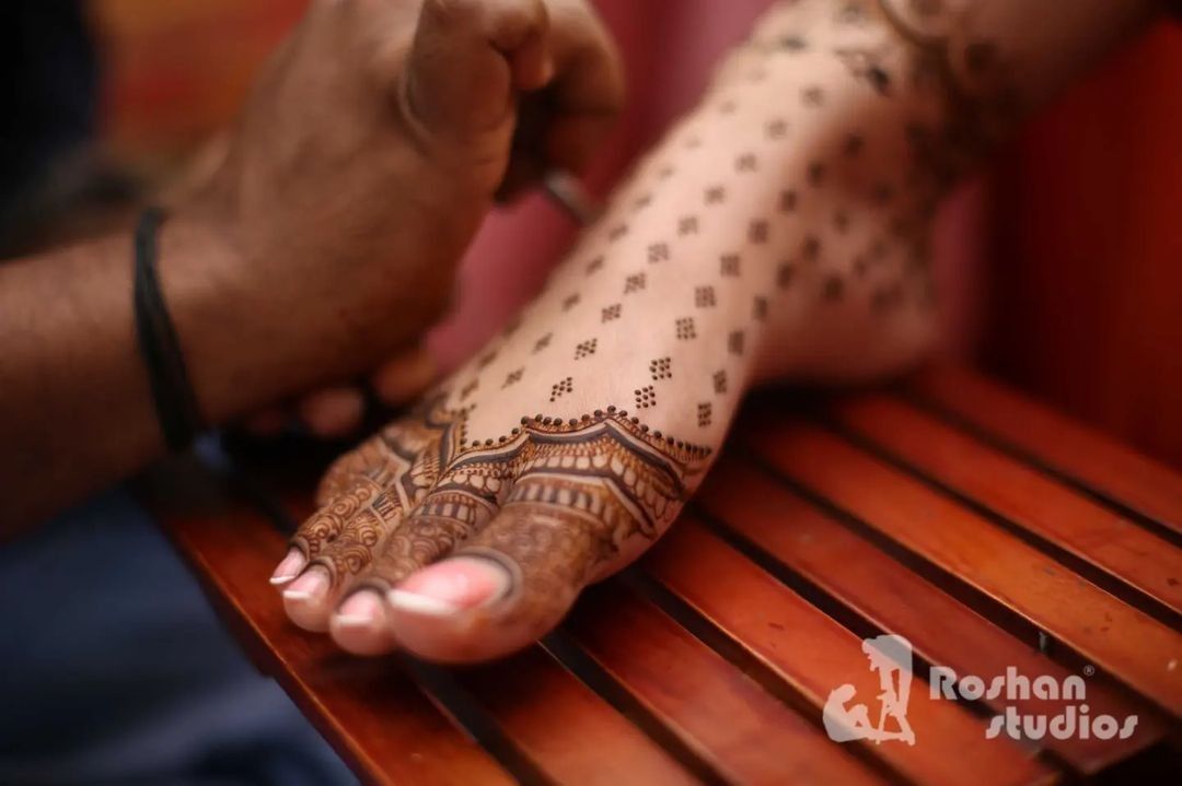 Minimal mehndi design with dainty dots for the feet