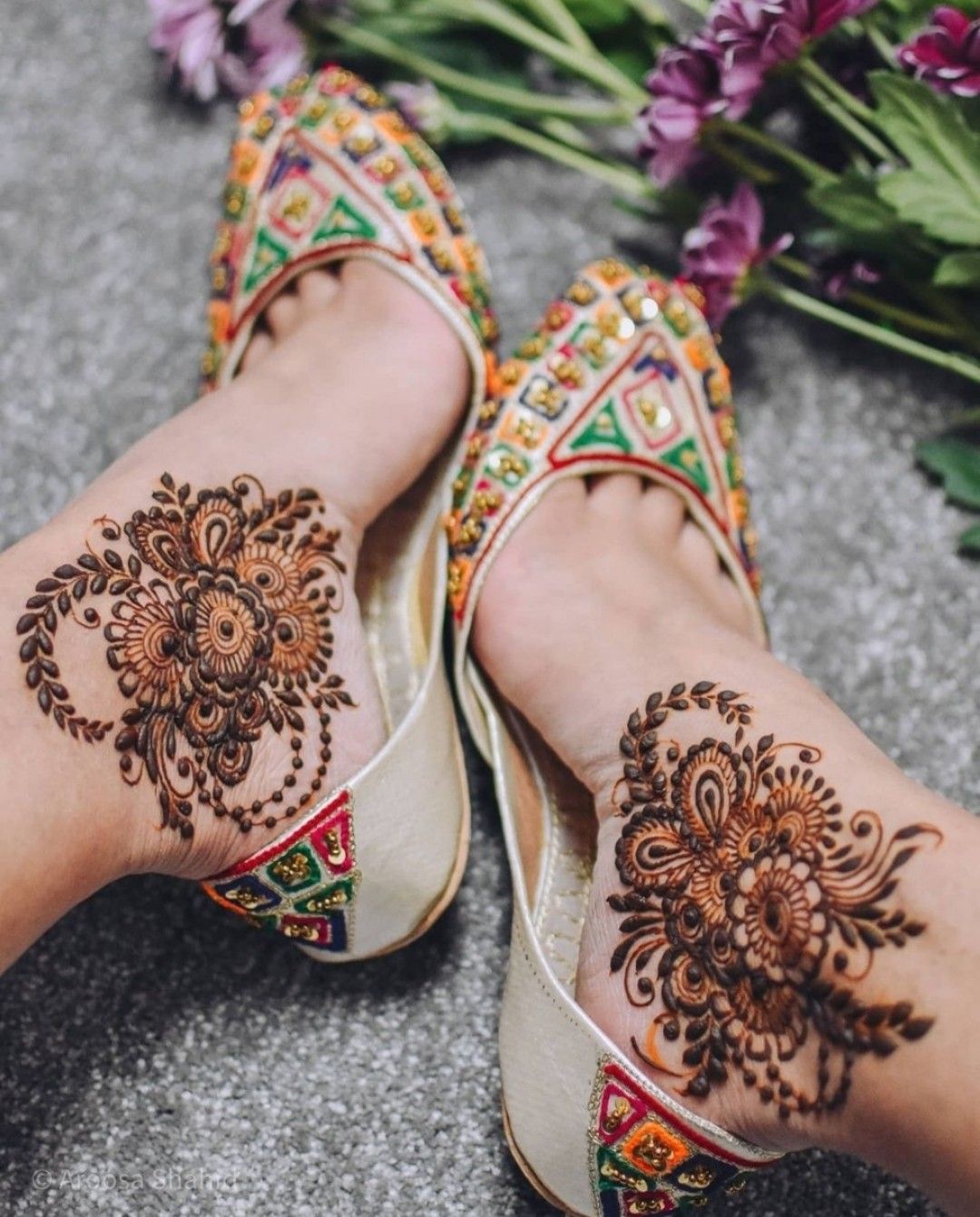 Minimal mehndi for feet with an ankle-only floral pattern