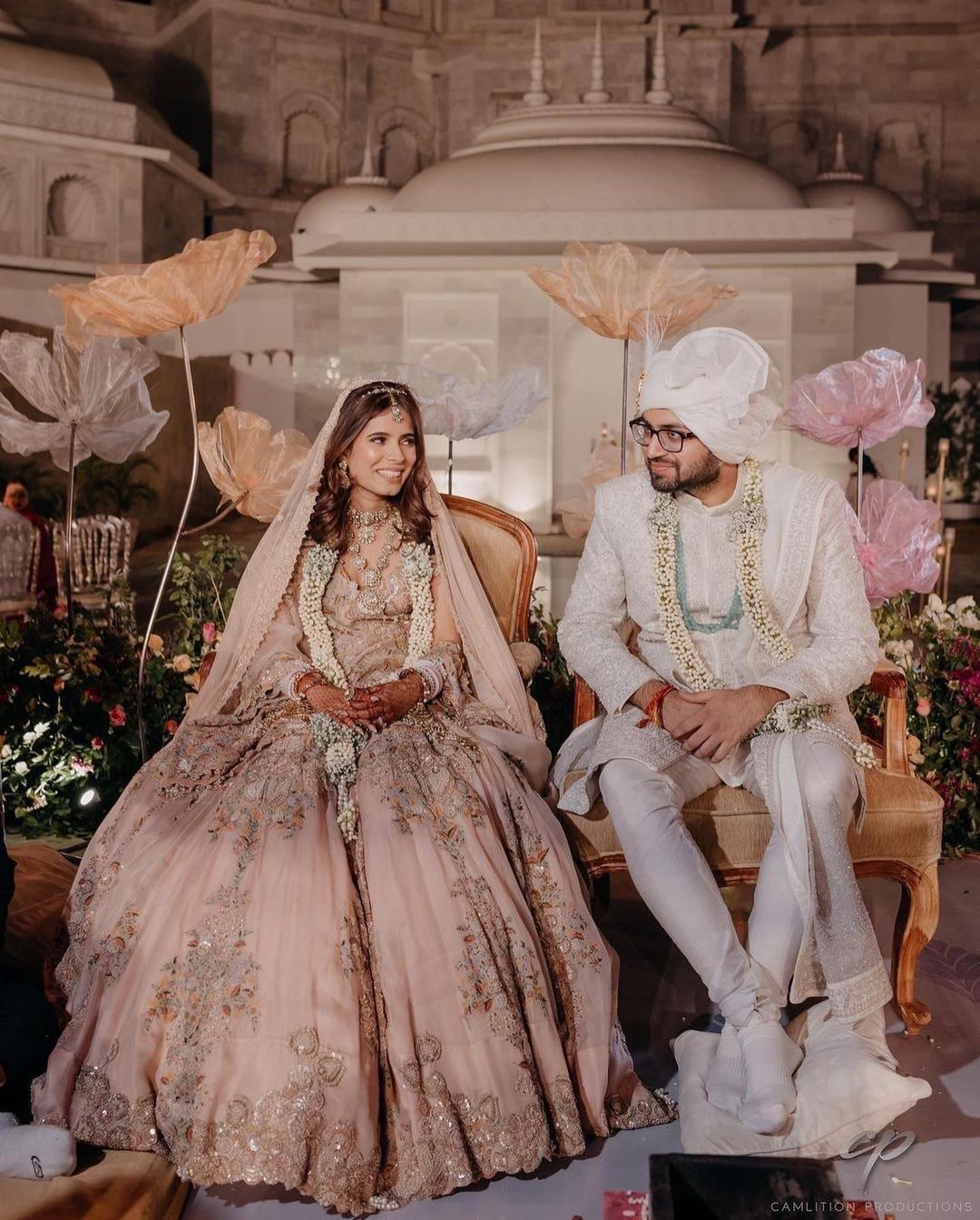 Photo of a couple sitting during their wedding 