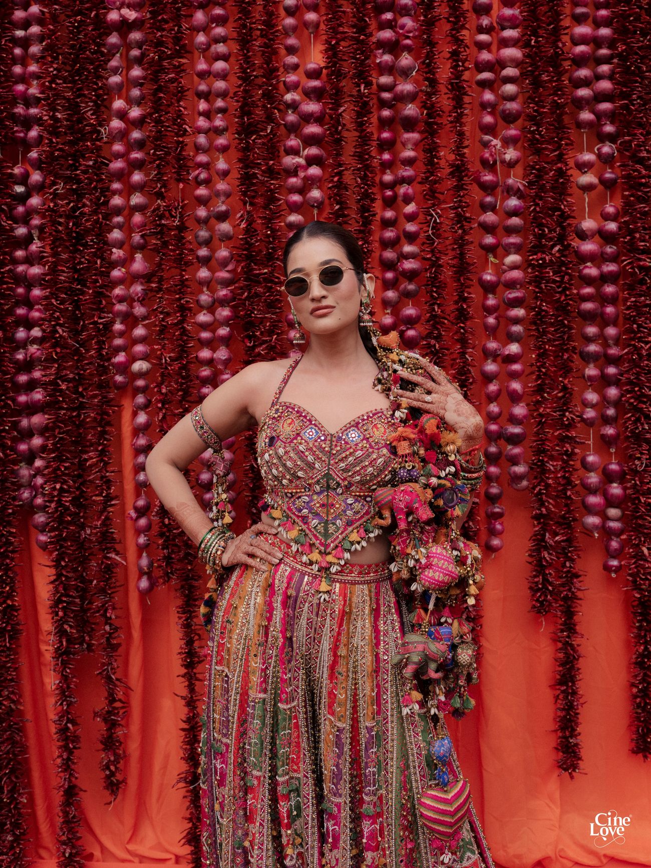 Bride in a vibrant Torani ensemble posing for wedding portraits