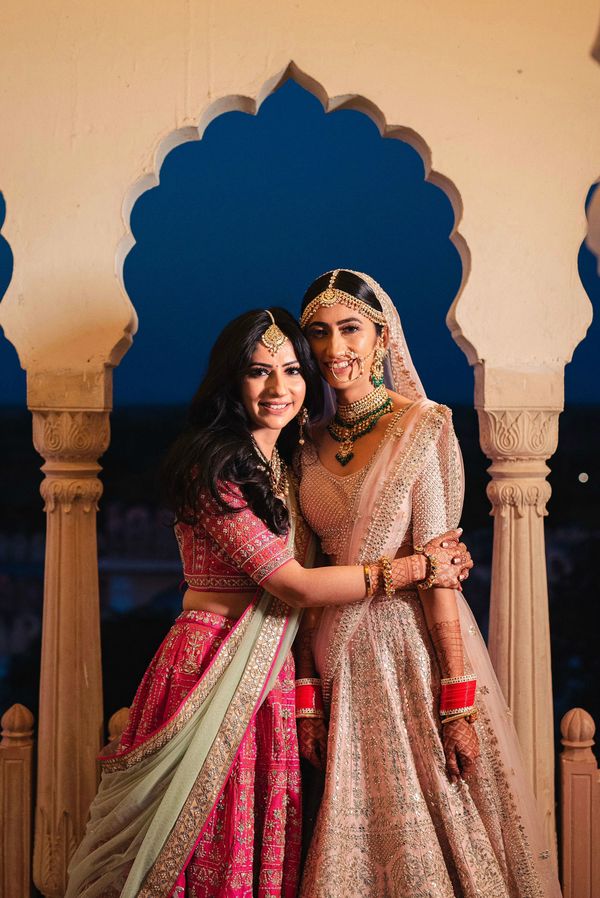 Brides-sister-writing-on-her-lehenga - Witty Vows