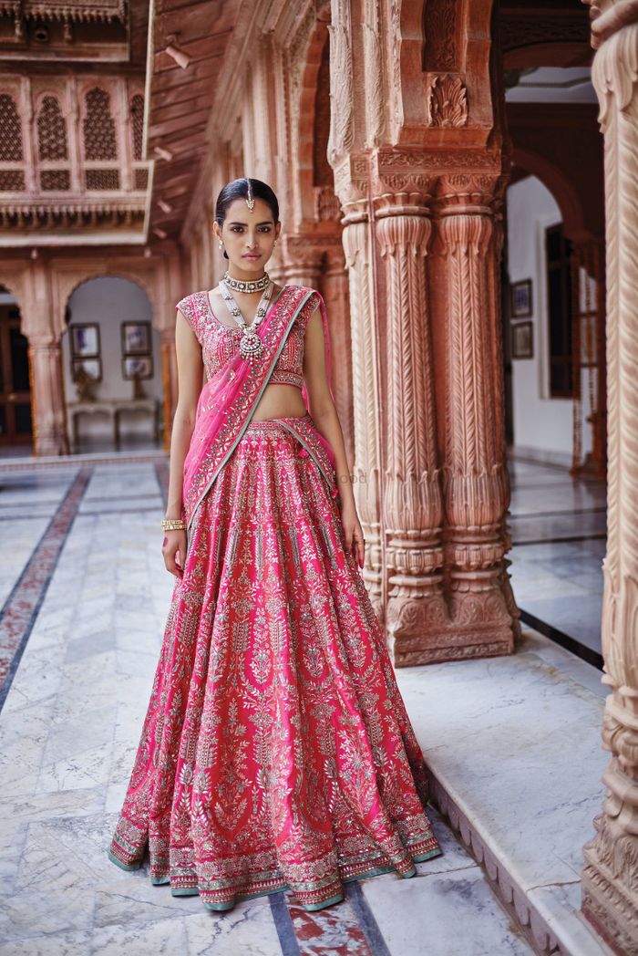 SHYAMAL & BHUMIKA - Bride Harmit in a Shyamal & Bhumika handcrafted lehenga  for her Wedding in Canada. Harmit wears a deep red tulle lehenga with  Eclectic blend of thread & aari