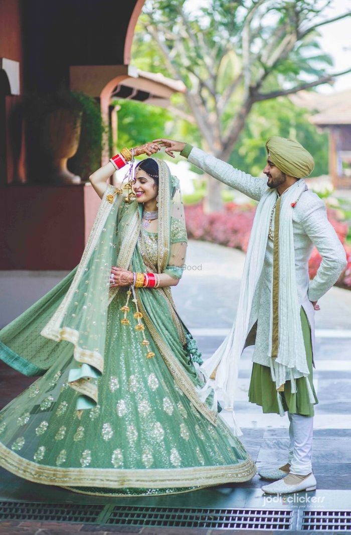 Beautiful couple portrait with pink lehenga |WedMeGood| Divya & Karan  |#wedmegood #i… | Engagement dress for groom, Couple wedding dress,  Engagement dress for bride