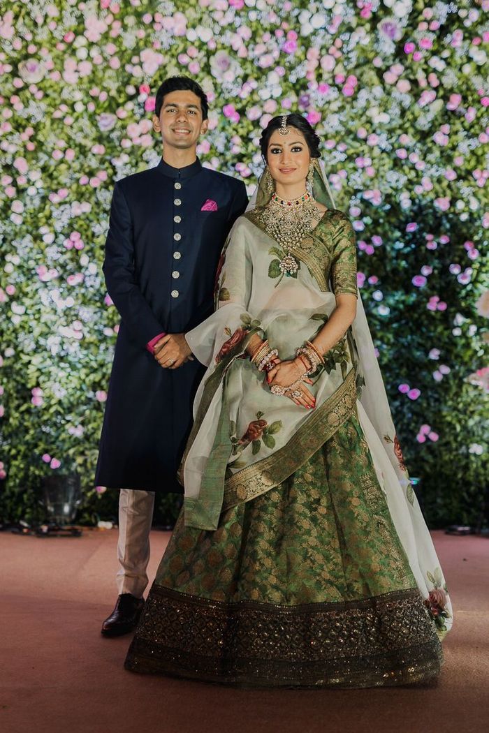 Bride twirling in dark green lehenga with groom | Couple wedding dress,  Dark green lehenga, Wedding outfit