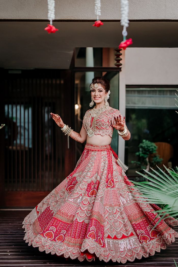 Kajal Aggarwal's red Anamika Khanna bridal lehenga featured stunning  Kashmiri resham work | VOGUE India