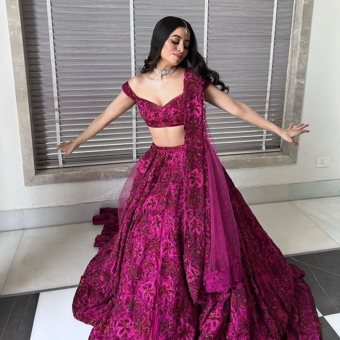 Natasha Dalal - A whimsical Dupion Silk Lehenga teamed with a cold shoulder  blouse accentuated with fringe trimmings and embellishments. The most  interesting aspect of this lehenga is the two tiered skirt