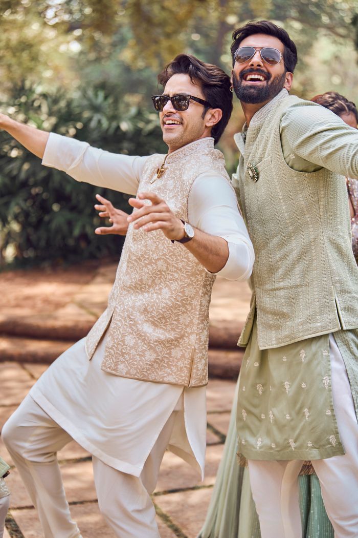 sachin and babi light blue dress Studio shot of young bearded Indian Sikh man wearing smart casual clothes  against brown background Stock Photo main image 1