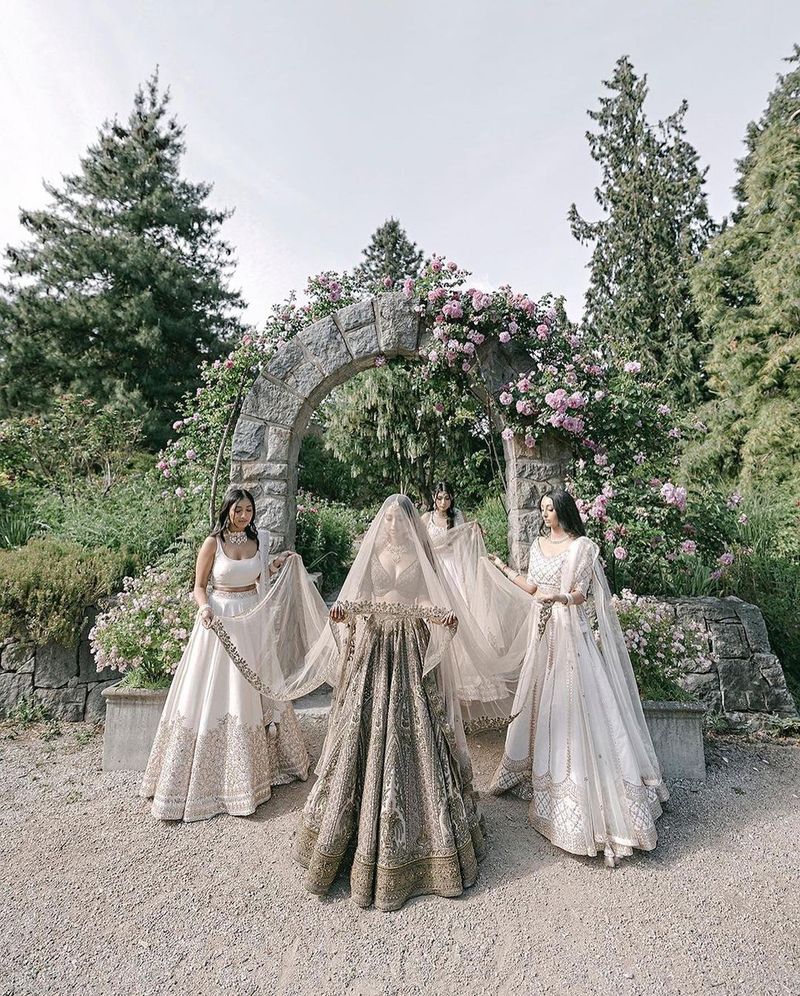 Friends forming a canopy over the bride during her entry