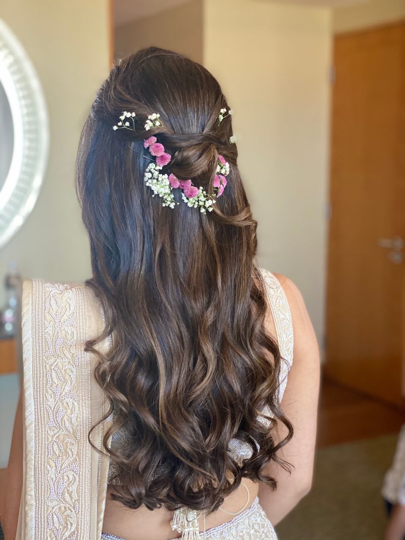 Soft loose curls with minimal flowers for a reception