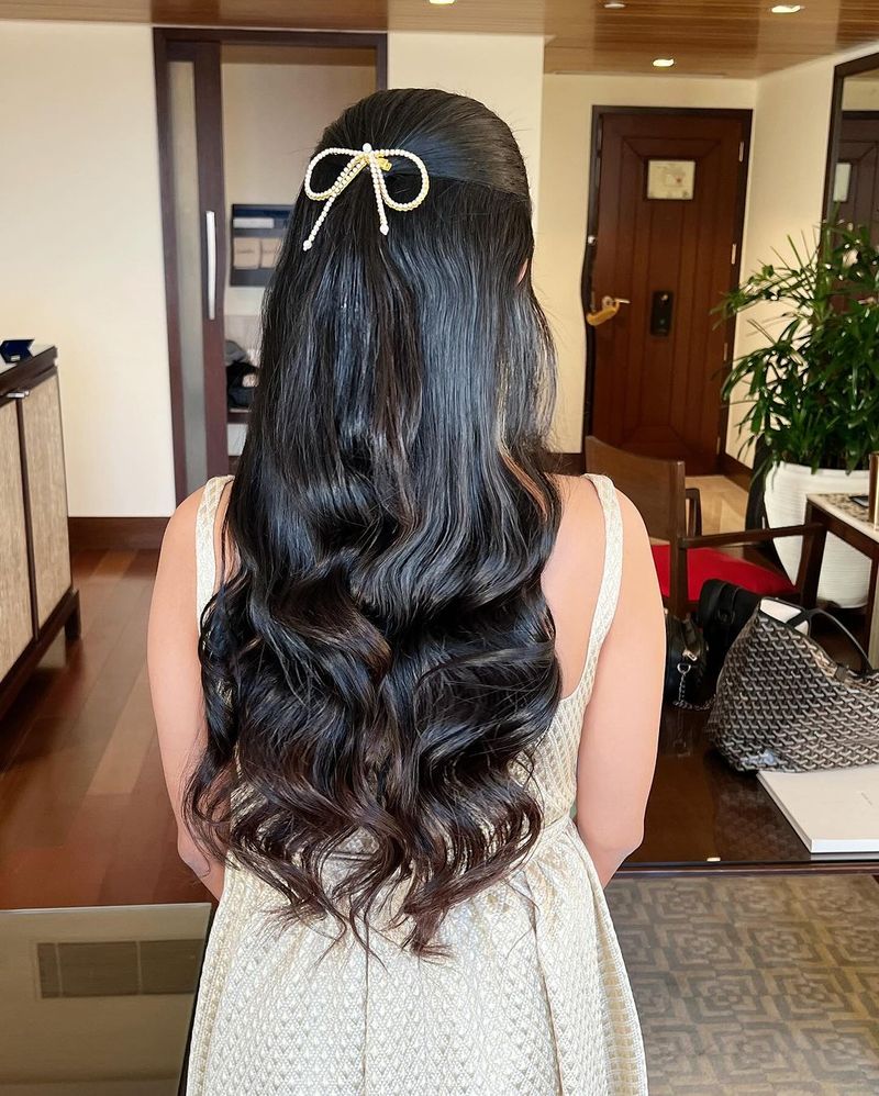 Bridal reception hairstyle finished with a bow