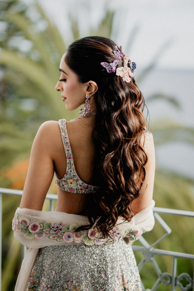 Cascading curls pinned with pastel butterfly clips