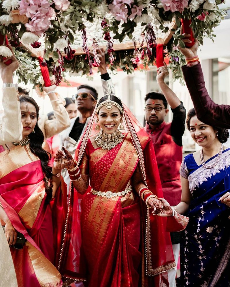 Bride taking a slow, measured walk towards the mandap