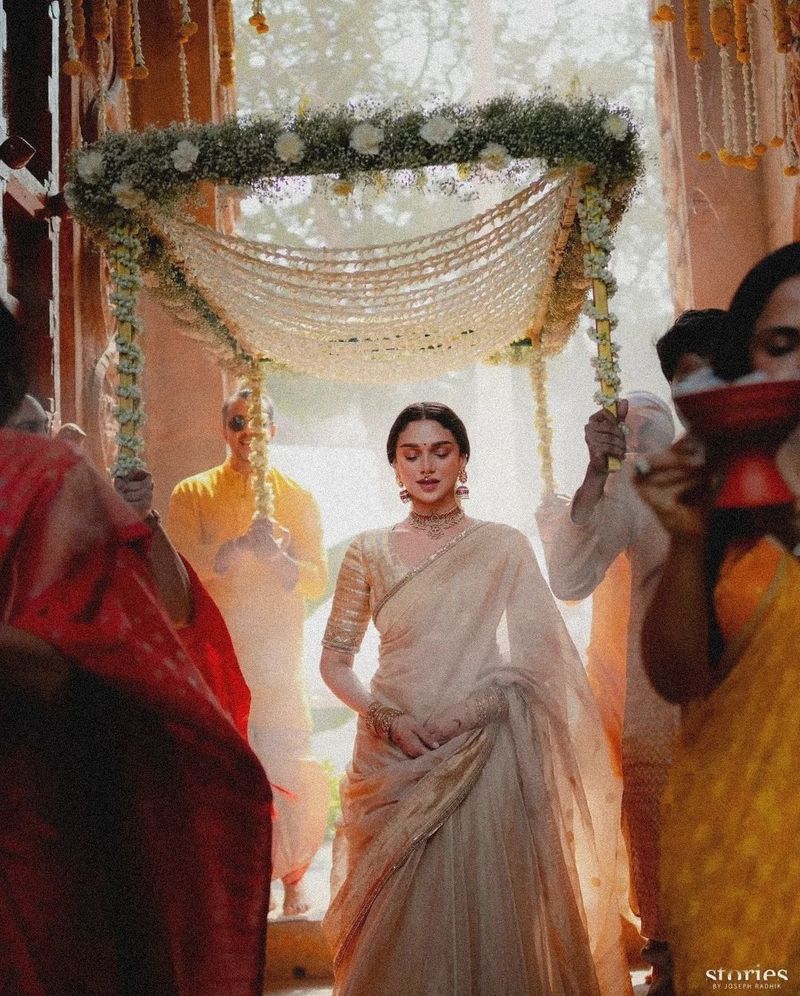 Bridesmaids carrying dhoop ahead of the bride