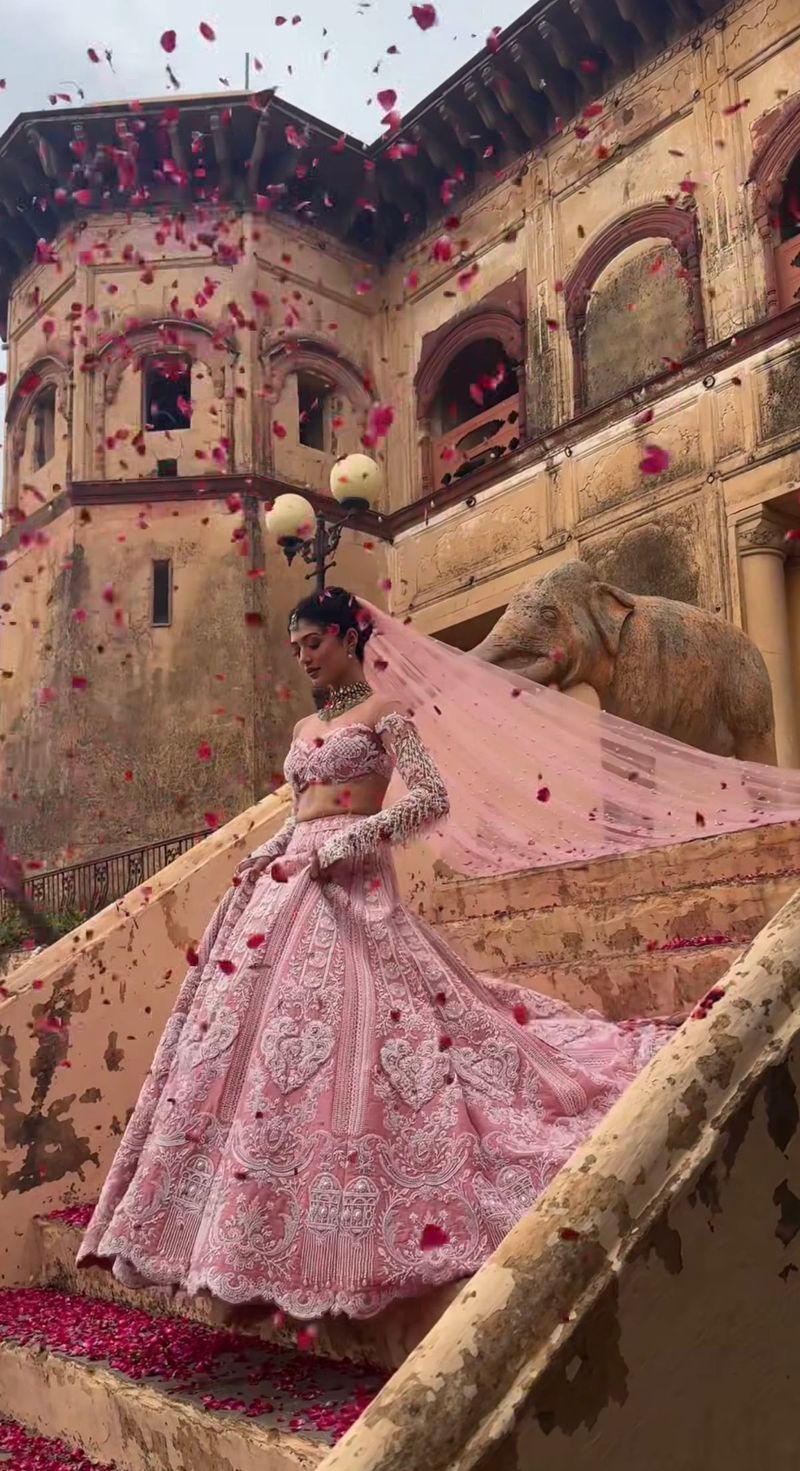Petals falling over the bride during her wedding entry