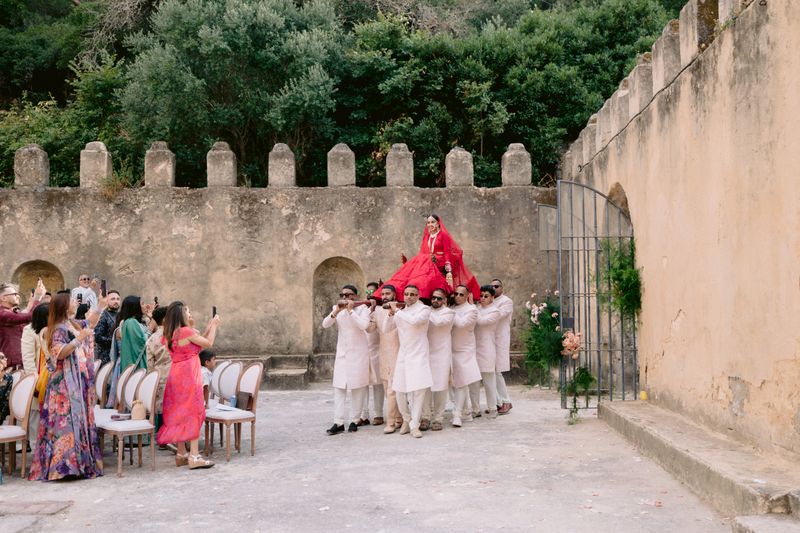 Bride arriving in an open doli during her wedding entry