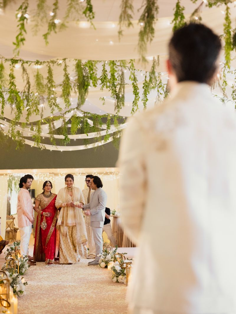 Bride walking into her wedding with her sibling