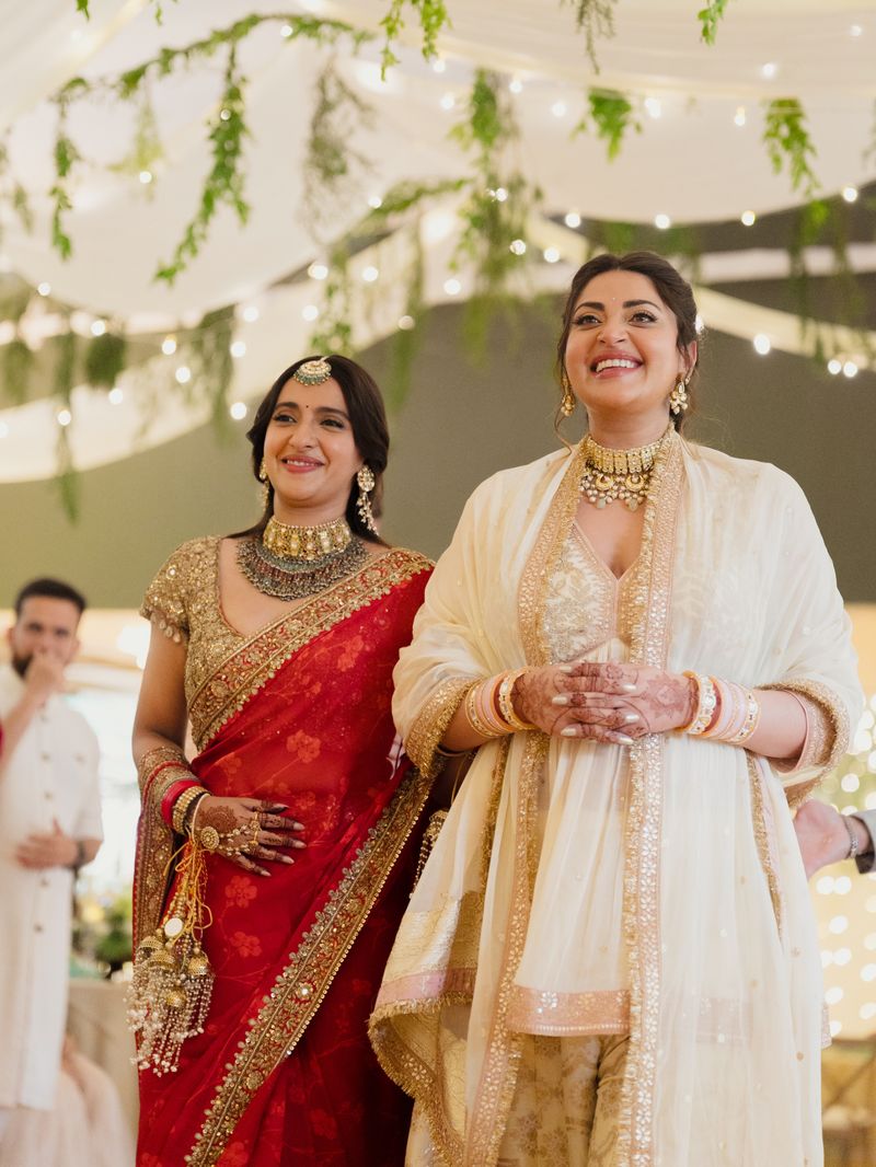 Sibling walking beside the bride during the entry
