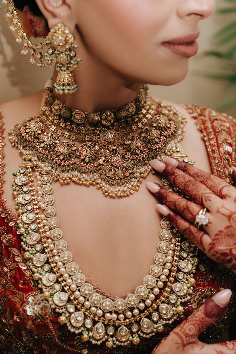 Shoulder necklace sitting wide across the collarbone