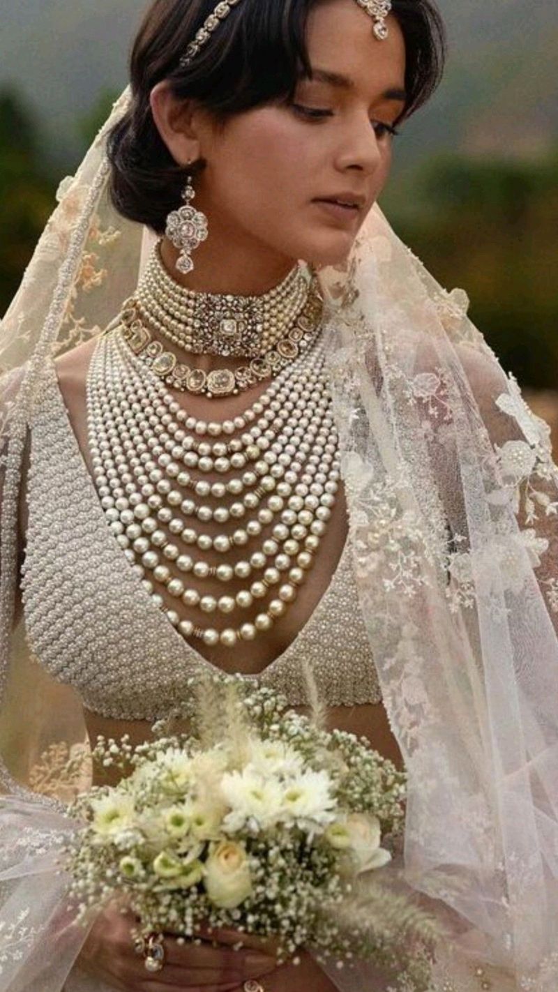 Oversized pearl earrings with a stacked pearl necklace