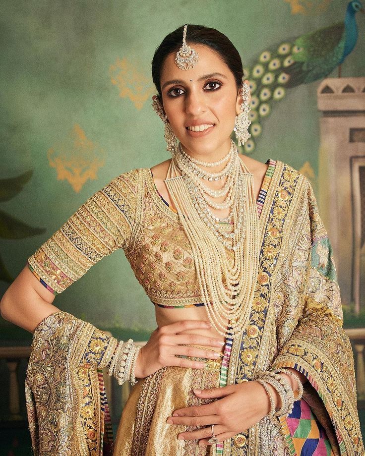 Stacked pearl necklaces layered over a bridal blouse