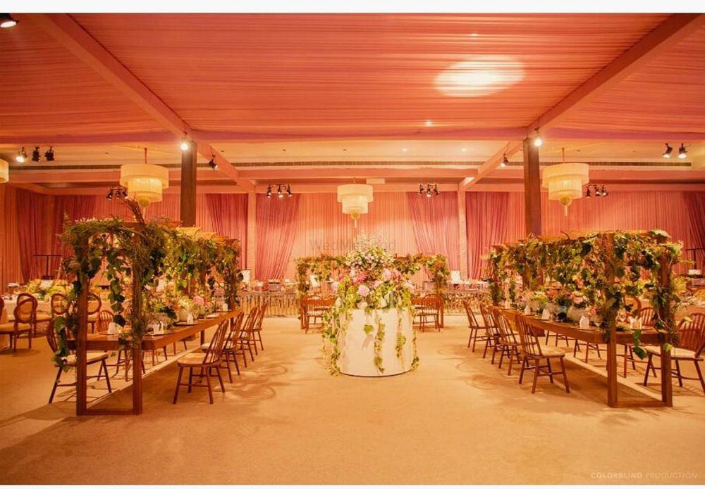 Photo of long table seating idea for wedding indoors and floral decor