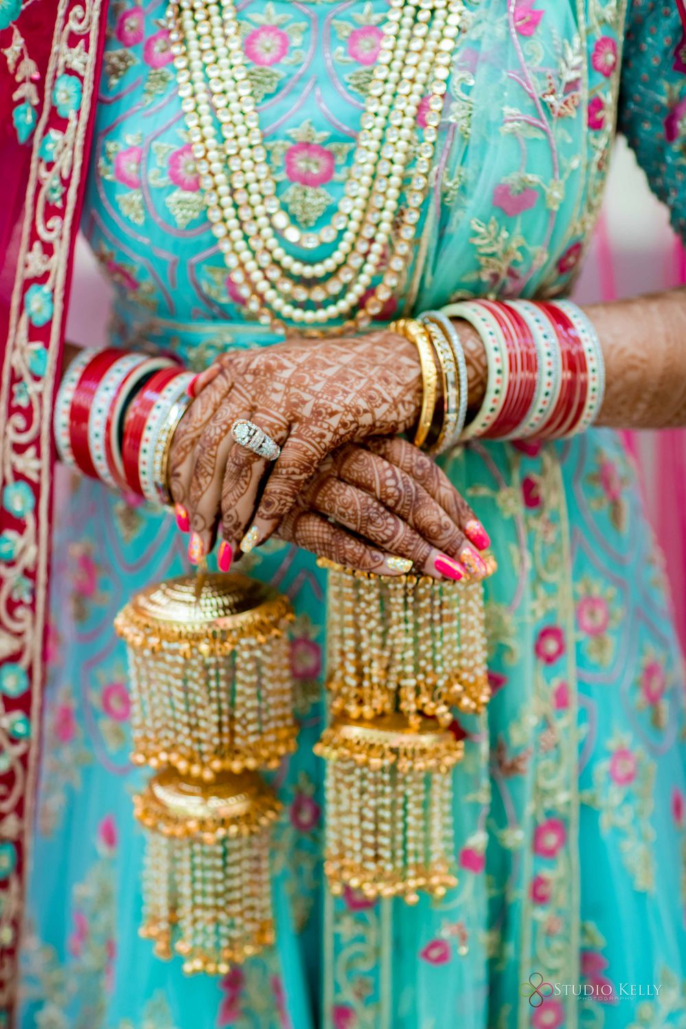 Photo of bridal hands with kaleere and a red chura