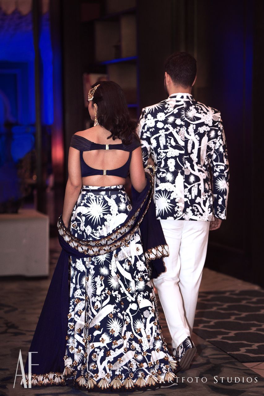 Photo of Twinning bride and groom in matching cocktail outfits