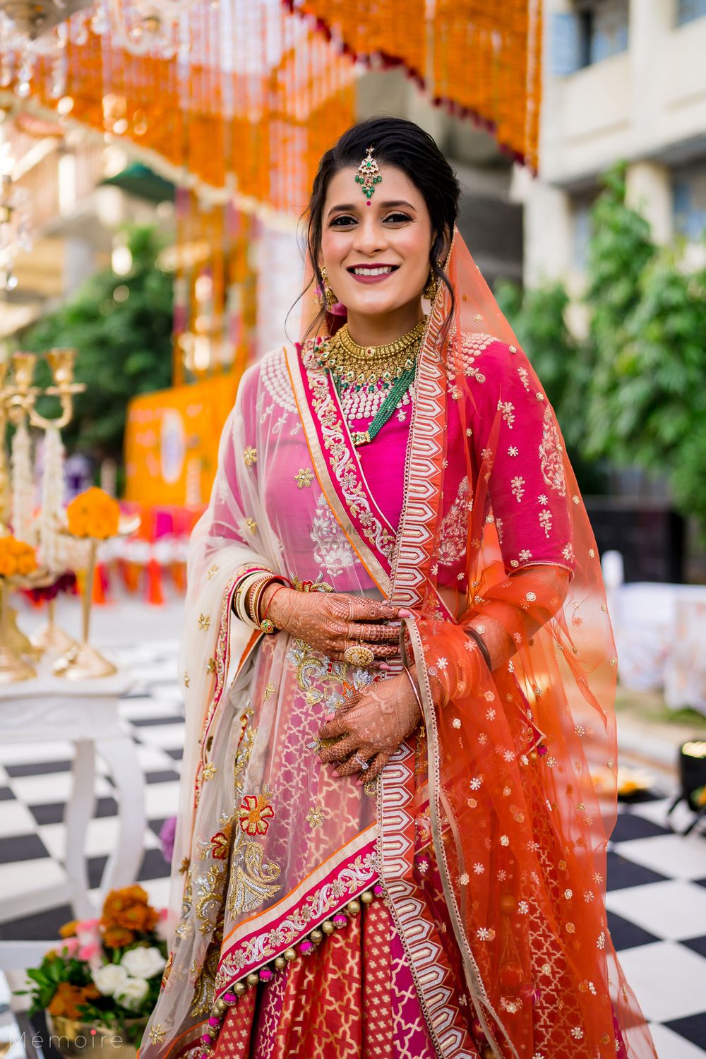 Photo of Wedding day bridal portrait in a pink & orange lehenga