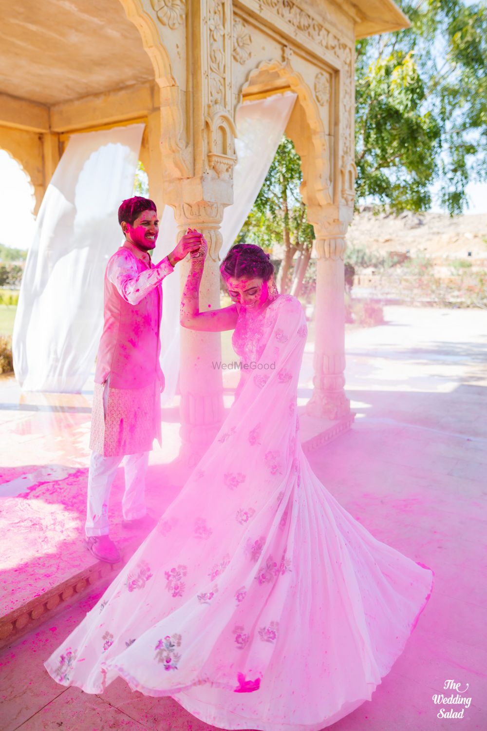 Photo of couple shot with twirling bride during holi mehendi