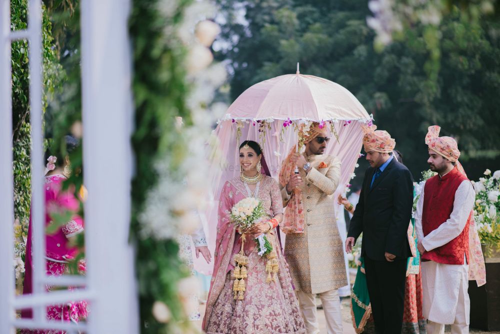 Photo of Gorgeous bridal entry under umbrella