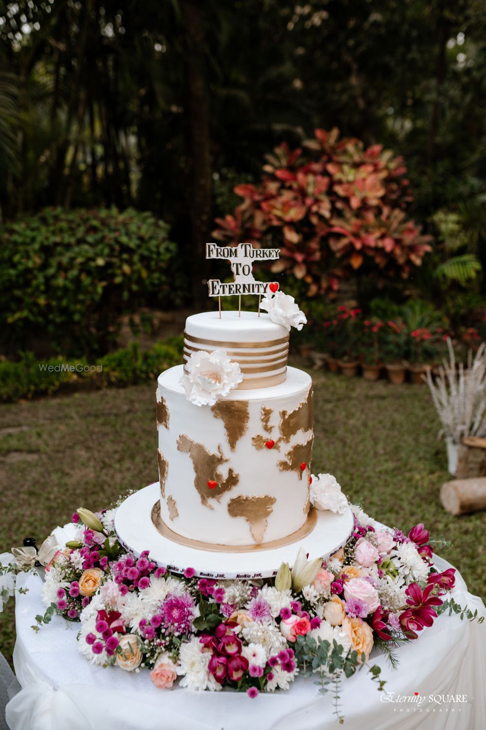 Photo of engagement cake shot with world map on it