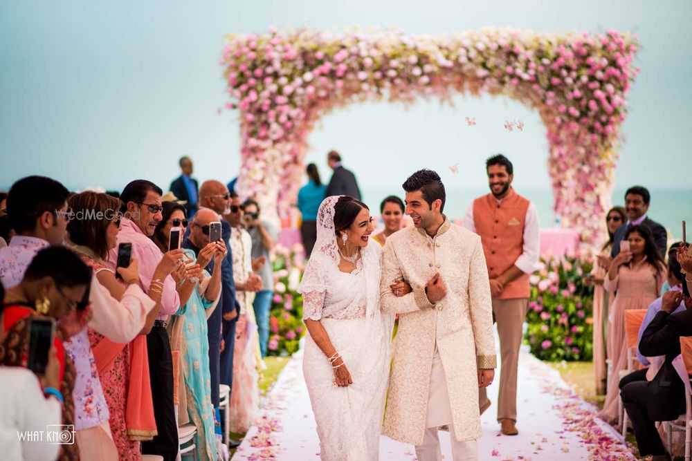 Photo of A bride and groom in coordinated outfits for their wedding