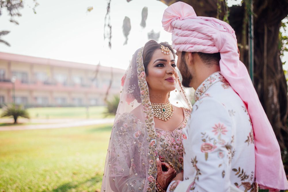 Photo of Floral sherwani matching bride and groom