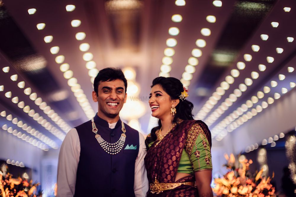 Photo of A to-be south Indian bride wearing a saree with a kamarbandh, posing with her to-be husband
