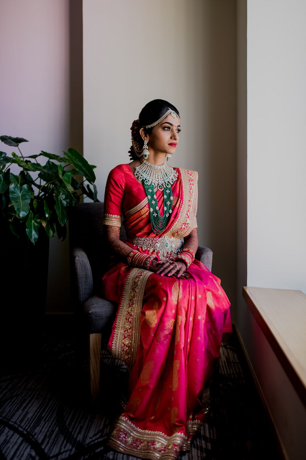 Photo of A south Indian bride in a red kanjeervaram and layered jewelry