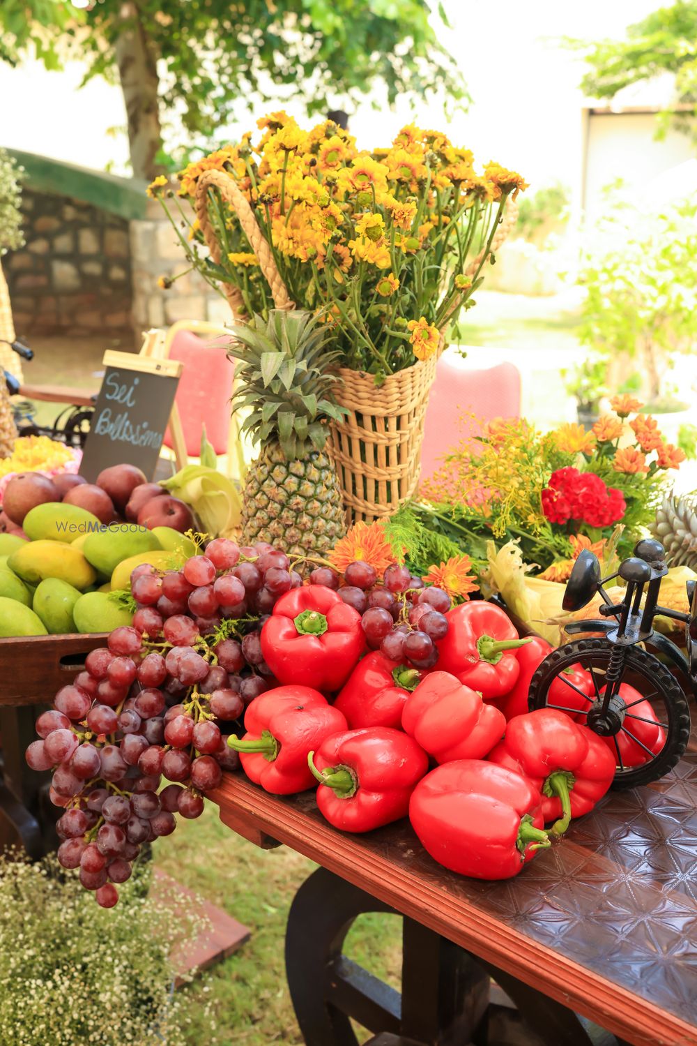 Photo of Funky decor elements with fruits and vegetables for farmers market themed mehendi