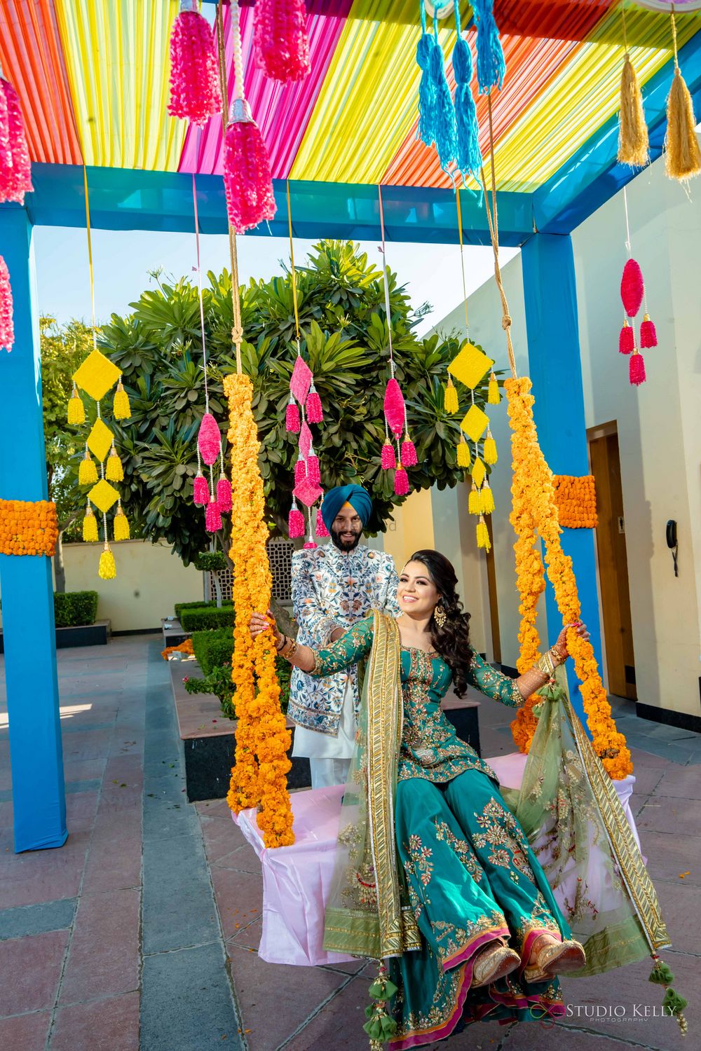 Photo of swing decor idea for mehendi with bride and groom