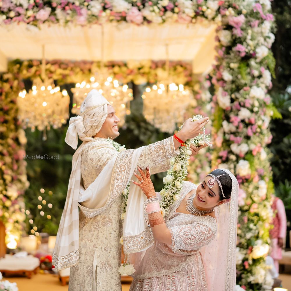 Photo of Cute and fun moment captured during the varmala garland exchange between the couple
