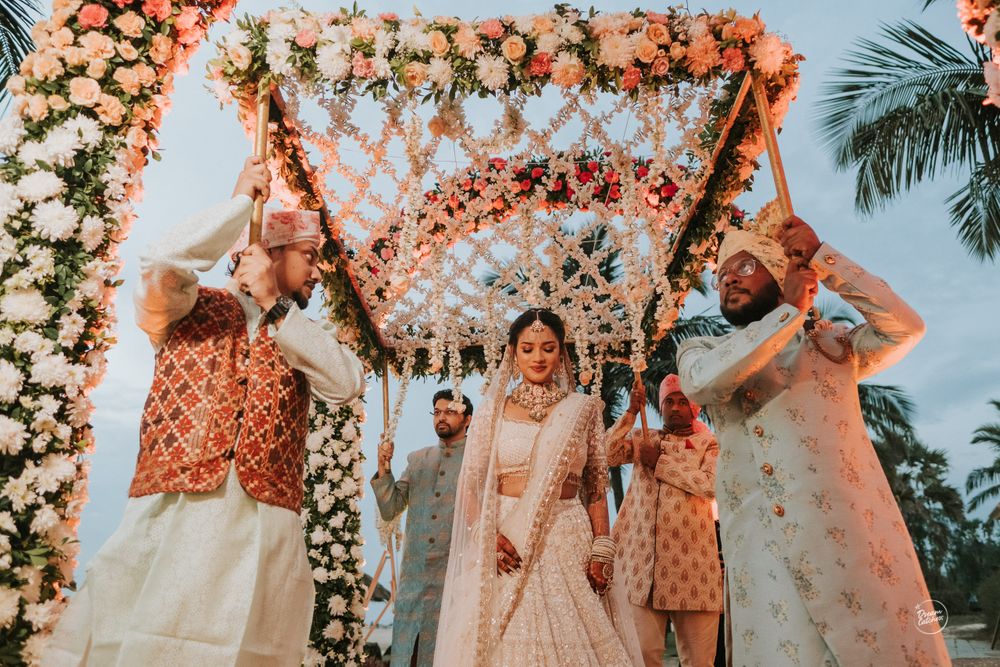 Photo of bride entering under phoolon ki chadar with her brothers