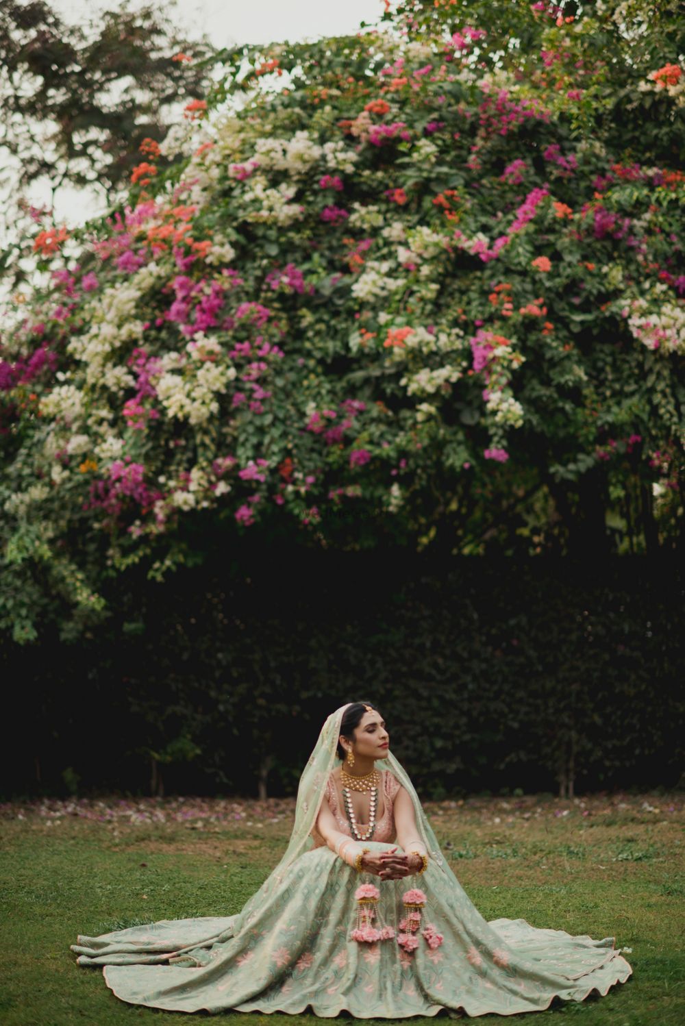 Photo of Outdoor bridal shoot with peach and green lehenga