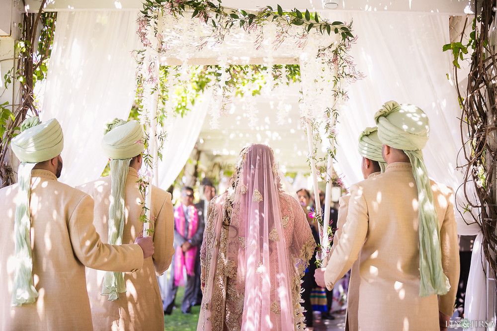 Photo of Bride entering under phoolon ki chadar for pastel themed wedding